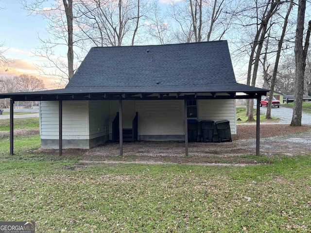 outdoor structure at dusk with an outdoor structure and a yard