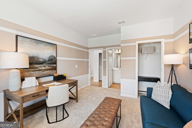 office space with light colored carpet and visible vents