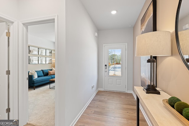 entryway featuring light wood finished floors, recessed lighting, and baseboards