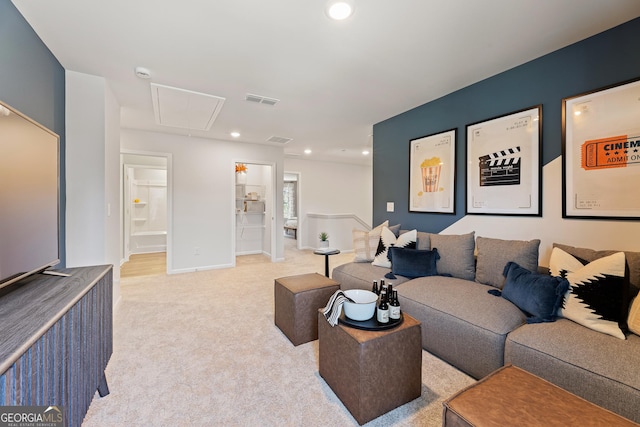 living area with recessed lighting, attic access, visible vents, and light colored carpet