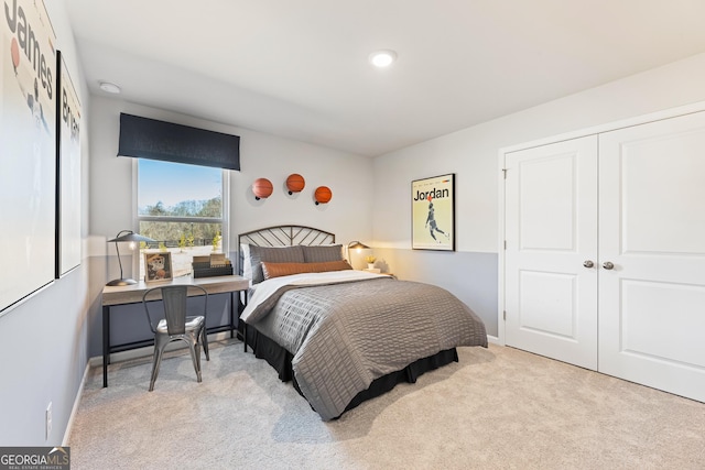 bedroom featuring light carpet, baseboards, and a closet