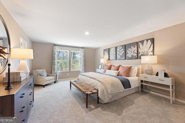 bedroom with light carpet, recessed lighting, and baseboards