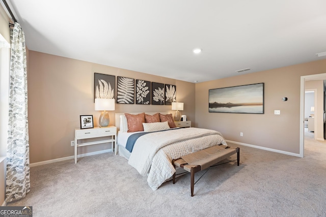 bedroom featuring visible vents, light carpet, and baseboards