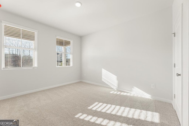 unfurnished room featuring carpet floors and baseboards