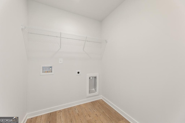 laundry area featuring laundry area, baseboards, wood finished floors, hookup for a washing machine, and electric dryer hookup