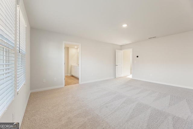 interior space with recessed lighting, light carpet, and baseboards