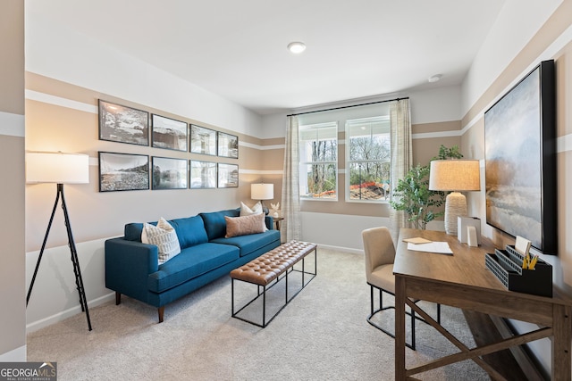 office space featuring baseboards and light colored carpet