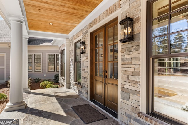 view of exterior entry featuring stone siding