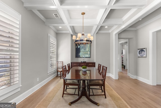 dining area with light wood-type flooring, visible vents, baseboards, and an inviting chandelier