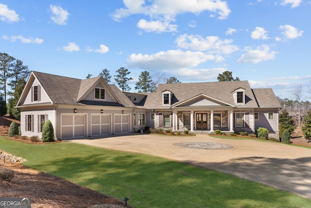 view of front of property with a front yard, roof with shingles, driveway, and an attached garage