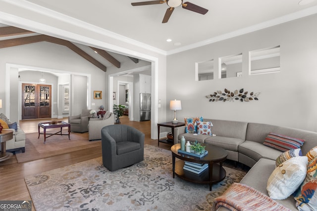 living room featuring vaulted ceiling with beams, recessed lighting, a ceiling fan, ornamental molding, and wood finished floors