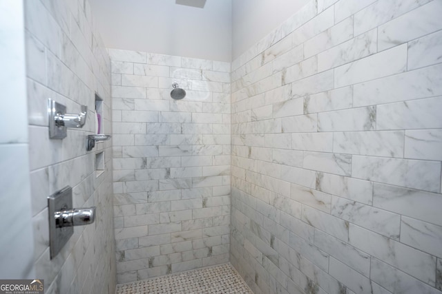 bathroom with tiled shower