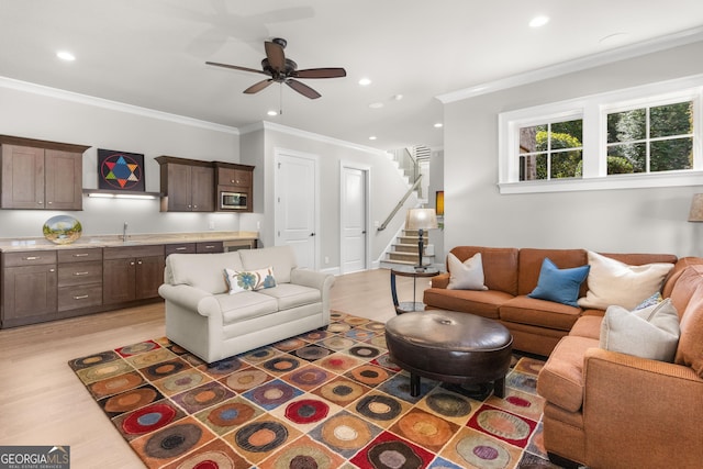 living room with stairway, recessed lighting, light wood-style flooring, and crown molding