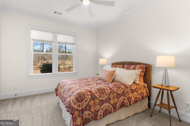 bedroom featuring ornamental molding, visible vents, light carpet, and baseboards