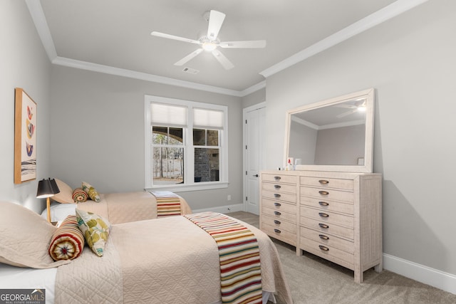 bedroom featuring carpet floors, visible vents, baseboards, and ornamental molding