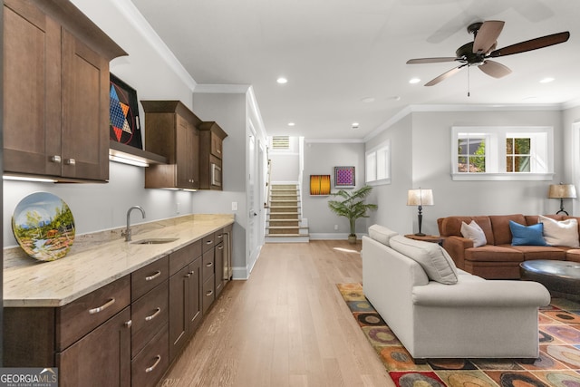 living area with light wood-style flooring, recessed lighting, baseboards, stairway, and crown molding