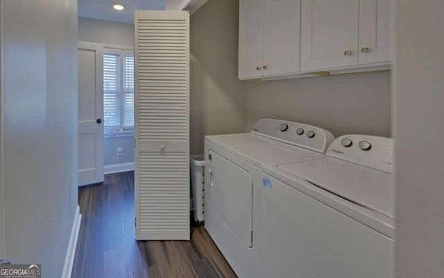 clothes washing area featuring cabinet space, baseboards, dark wood-type flooring, and washing machine and clothes dryer