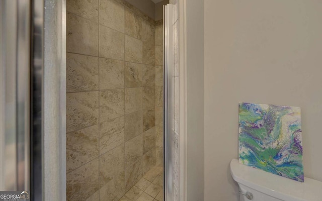 interior details with toilet and a stall shower