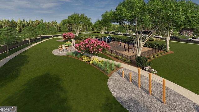view of home's community with playground community, fence, and a lawn