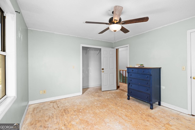 bedroom with ceiling fan, a closet, and baseboards