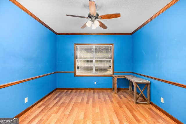 empty room with light wood-style floors, a textured ceiling, baseboards, and crown molding