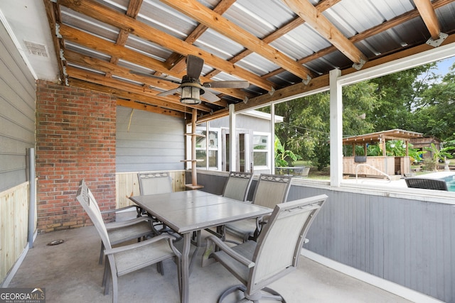 view of patio featuring a ceiling fan, outdoor dining space, and visible vents