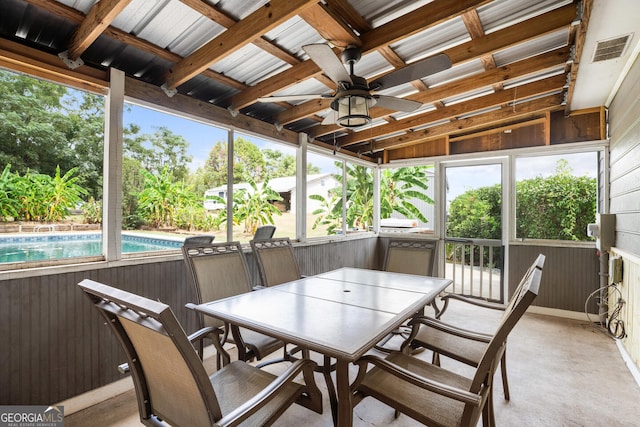 sunroom with a healthy amount of sunlight, visible vents, and ceiling fan