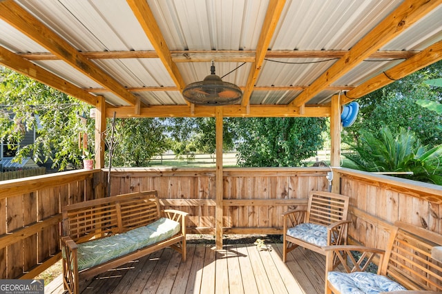 wooden deck featuring a ceiling fan