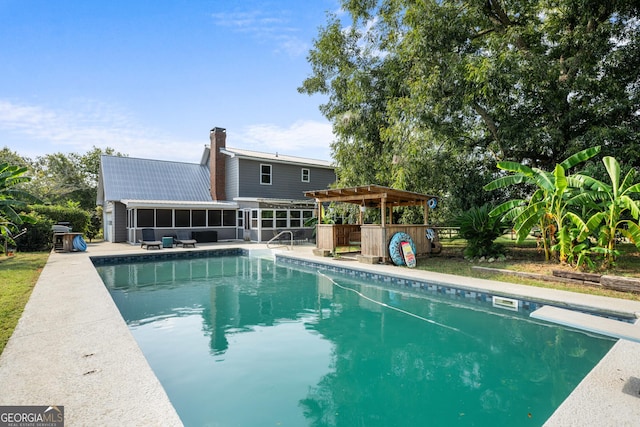 pool with a diving board, a sunroom, and a pergola