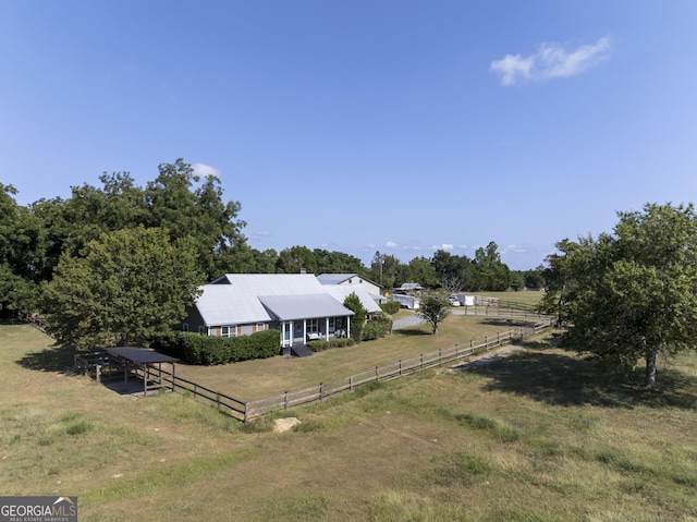 view of yard featuring a rural view and fence