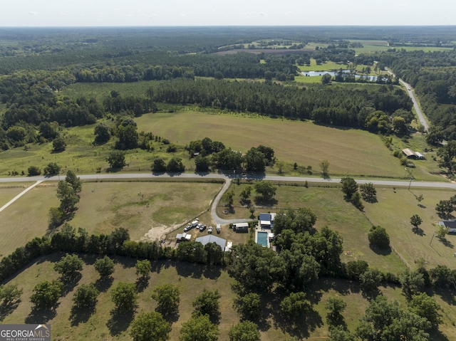 birds eye view of property with a forest view and a rural view