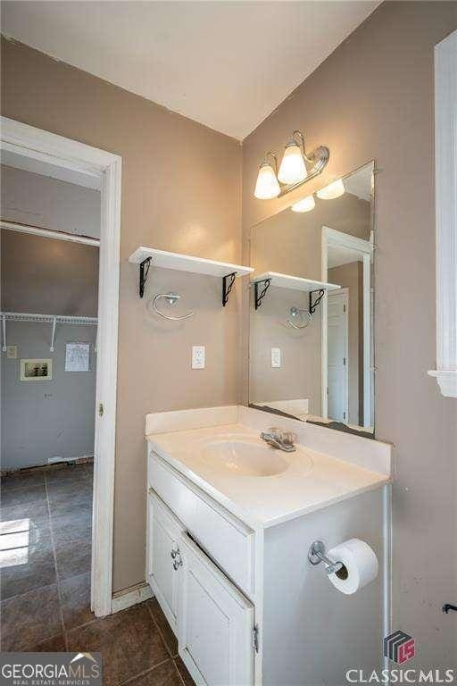 bathroom with tile patterned floors and vanity