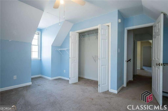 additional living space featuring light carpet, vaulted ceiling, baseboards, and ceiling fan