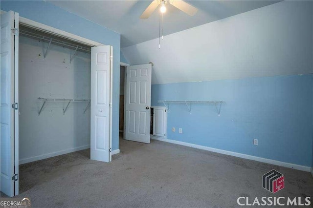 unfurnished bedroom with baseboards, vaulted ceiling, and a closet