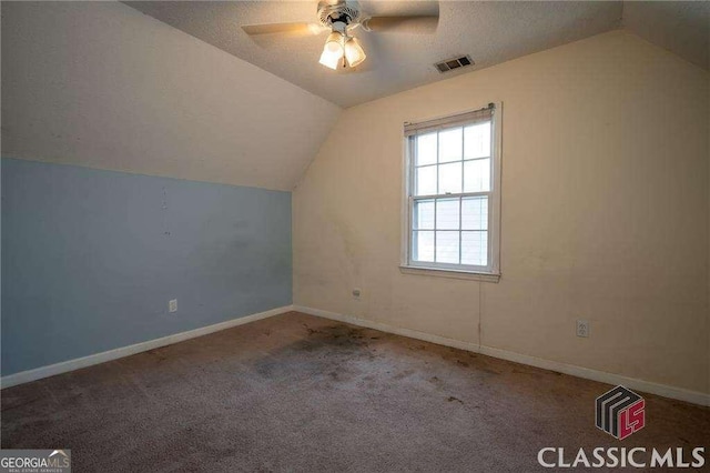 bonus room featuring carpet floors, lofted ceiling, visible vents, ceiling fan, and baseboards