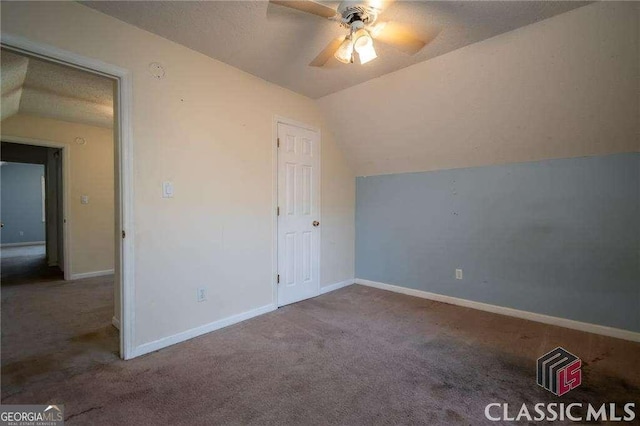 bonus room with carpet flooring, vaulted ceiling, baseboards, and ceiling fan