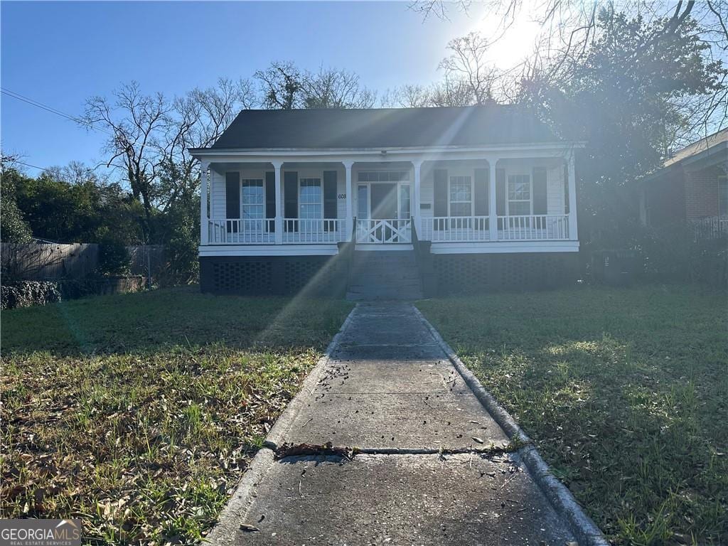 bungalow-style house featuring a porch and a front lawn