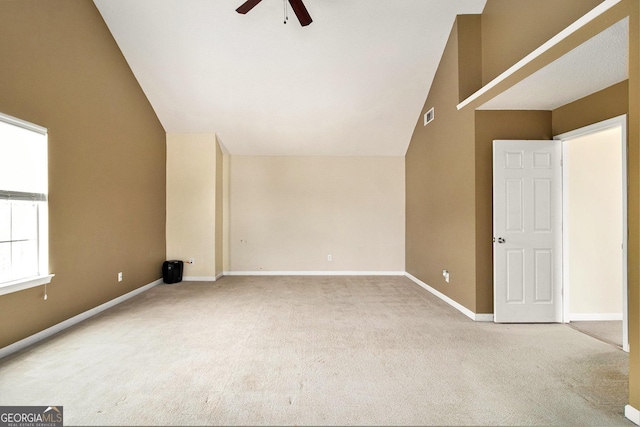 interior space with carpet floors, visible vents, ceiling fan, high vaulted ceiling, and baseboards