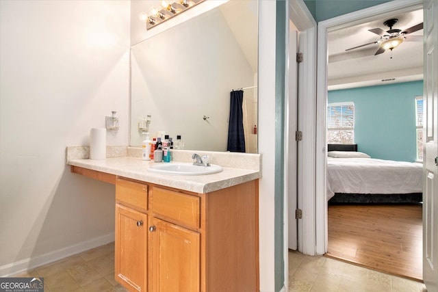 full bathroom featuring baseboards, connected bathroom, vanity, and a ceiling fan