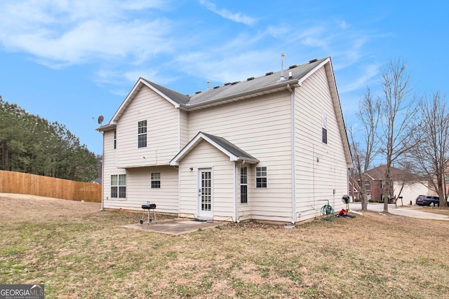 back of property featuring a yard, a patio area, and fence