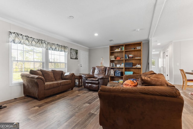 living area featuring ornamental molding, wood finished floors, and recessed lighting