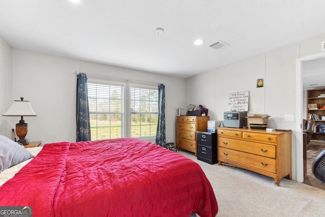 bedroom with light carpet and visible vents