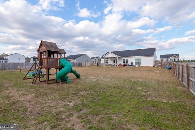 view of jungle gym featuring a residential view, a fenced backyard, and a yard