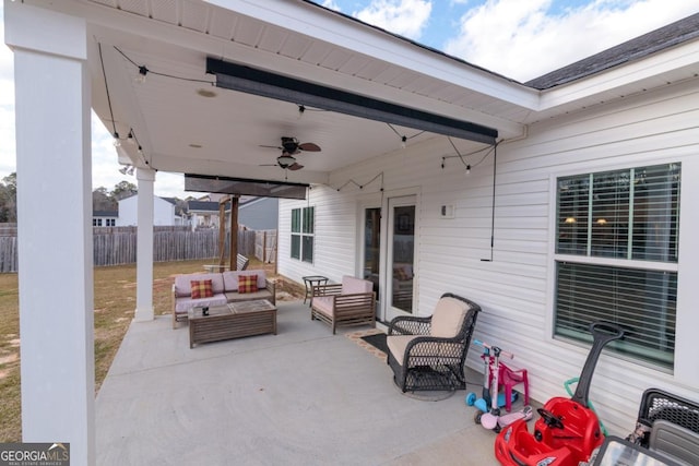 view of patio / terrace with fence, an outdoor hangout area, and a ceiling fan