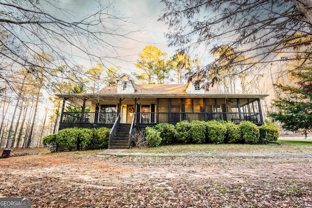 view of front of house featuring stairway and a porch