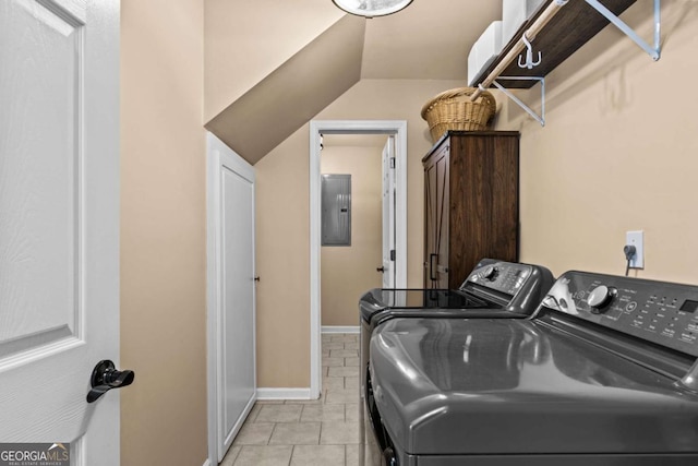 laundry room featuring light tile patterned floors, cabinet space, washer and dryer, electric panel, and baseboards