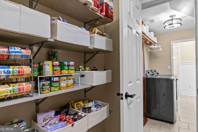 pantry featuring visible vents and separate washer and dryer