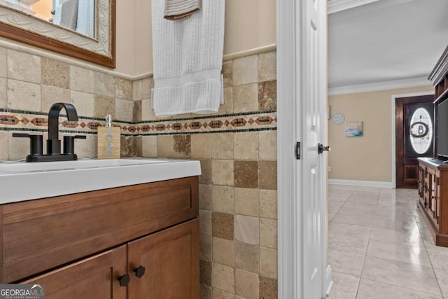 bathroom featuring tile patterned floors, tile walls, crown molding, and vanity