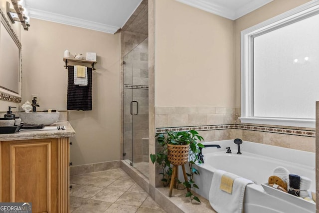 bathroom featuring a garden tub, vanity, baseboards, ornamental molding, and a shower stall