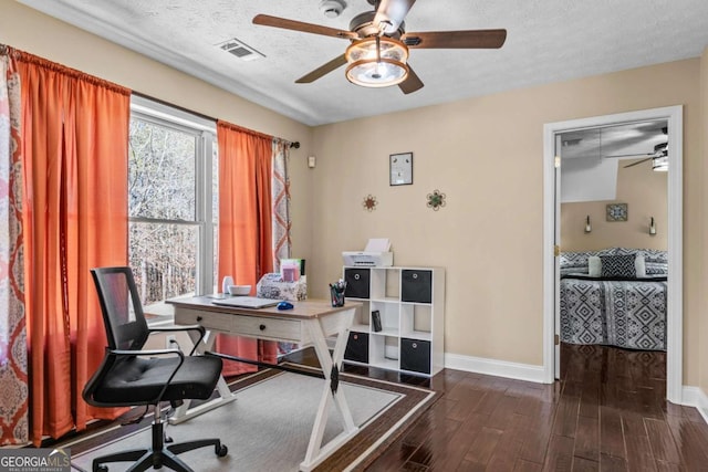 office with visible vents, baseboards, dark wood finished floors, and a textured ceiling